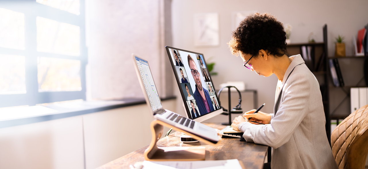 Individual participating in a virtual training event taking notes