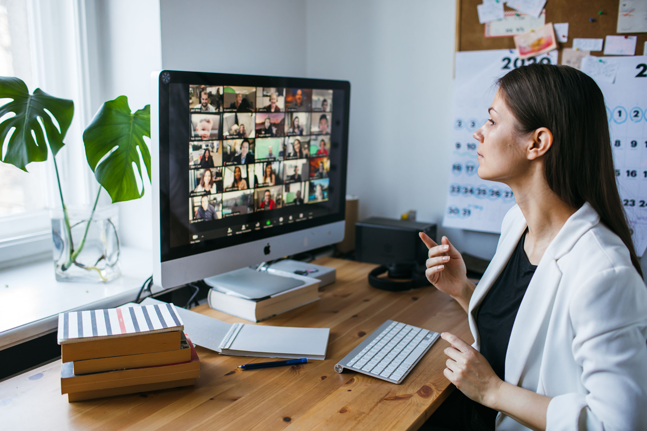 Woman on zoom meeting with other individuals