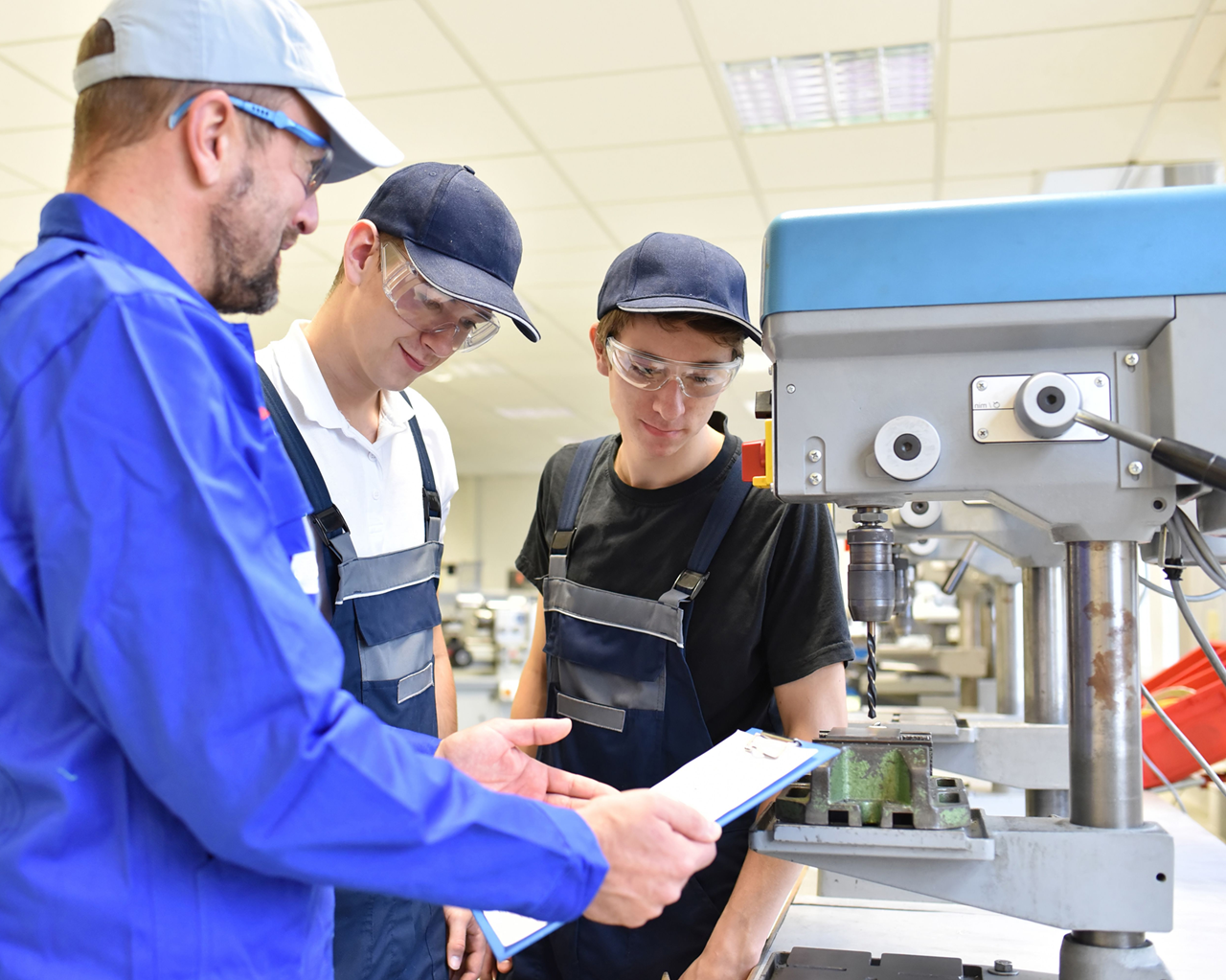 Career tech teacher works with students in a career tech lab